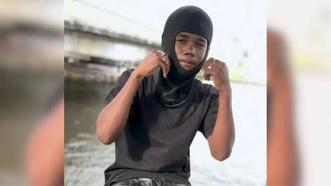 Police said the teen was shot after opening his door on Sunday night, with early investigations pointing to a dispute, as one suspect remains in custody.